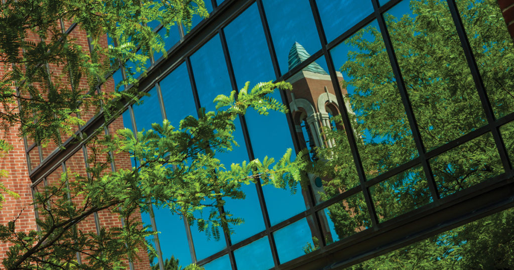 Shafer Tower reflected in campus windows.