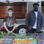 Photo of Ball State students at a produce table