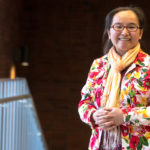 Dr. Chang smiling near a stairwell
