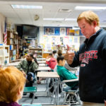 Teacher working with students in a classroom