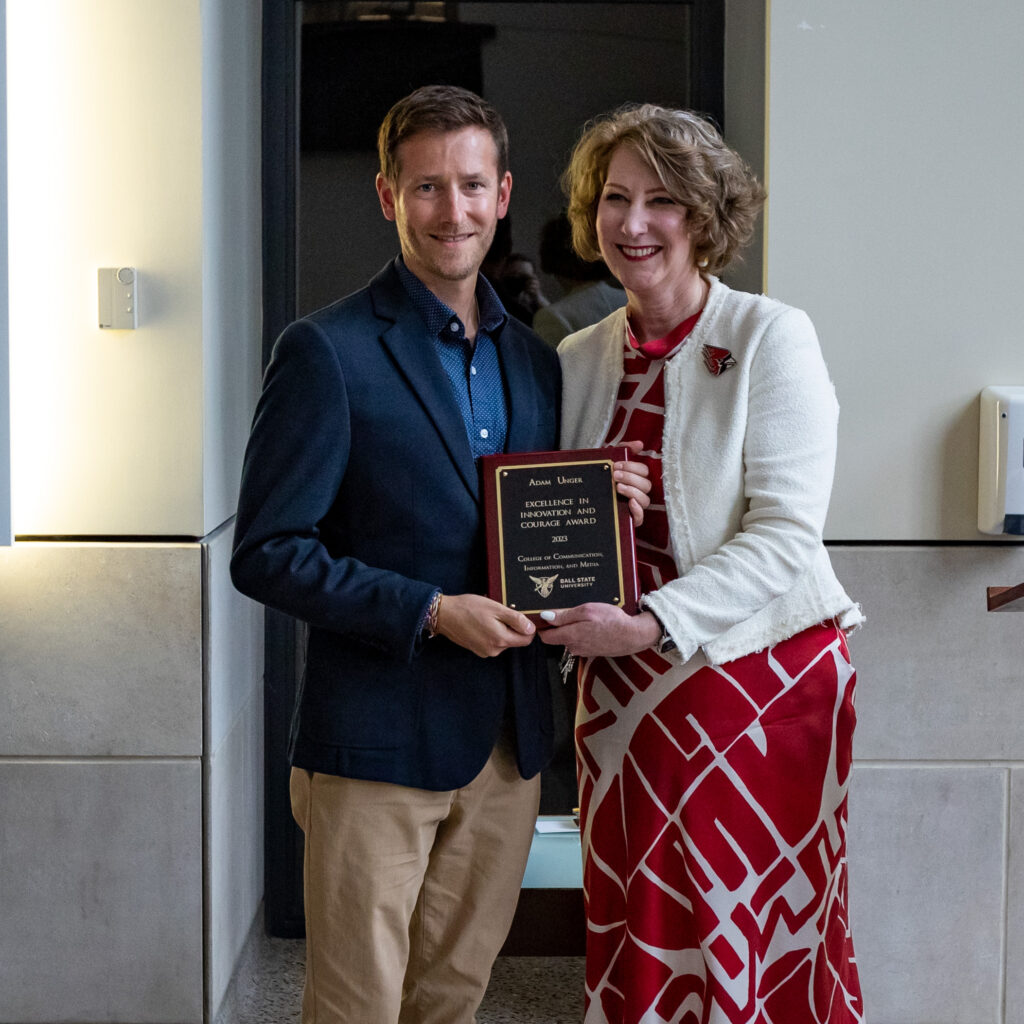 Adam Unger accepts a Hall of Beneficence Award