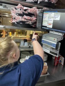 An Erskine Green trainee works in the kitchen at Roots Burger Bar